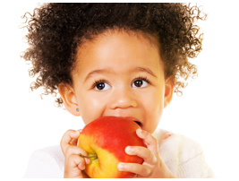 Image of a young girl eating an apple